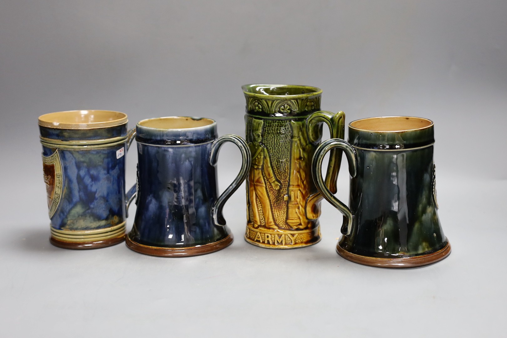 Three Royal Doulton stoneware rifle club commemorative mugs, early 20th century for Kensington rifle club and Surrey Yeomanry miniature rifle club together with an Our Army and Navy jug, tallest 16.5cm (4), Naval jug 16